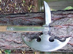 Unique knife embedded in tree trunk.