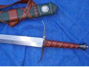 Sword with scabbard on blue fabric.