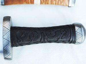 Decorative leather-wrapped sword hilt with silver pommel