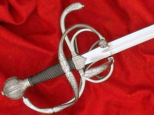 Ornate rapier sword on red fabric.