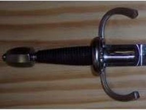 Sword hilt with wooden background.