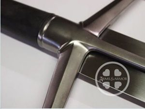 Sword hilt with logo, close-up view.