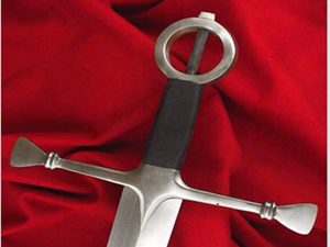 Sword on red fabric background.