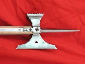 Decorative polearm weapon on red background.