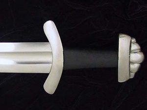 Sword hilt and blade on black background.