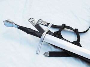 Sword with sheath and belt on display.