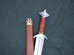 Sword and sheath on dark background.
