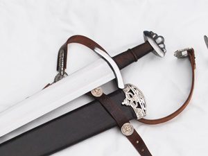 Sword with sheath and leather straps.