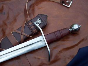 ornate medieval sword and scabbard on leather