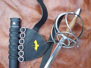 Rapier sword and sheath on leather background.