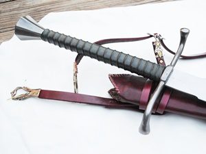Sword and leather scabbard on cloth.