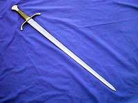 A medieval-style sword with a crossguard on a blue cloth.
