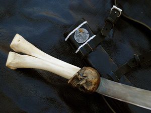 Sword with bone handle and leather straps.