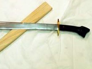 Sword with a black handle and sheath.