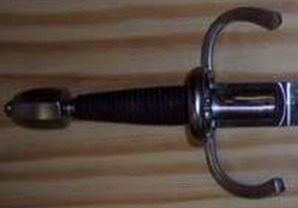 Sword hilt with wooden background.