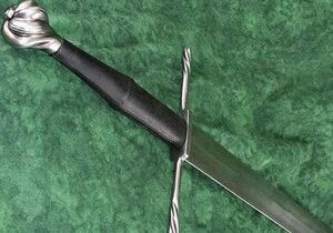 Medieval sword with ornate hilt on display.