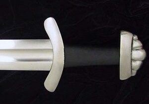 Sword hilt and blade on black background.