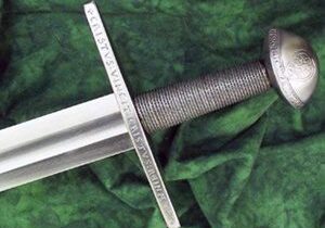 Medieval sword with engraved hilt on cloth.