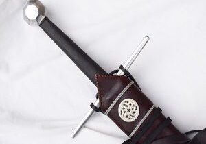 Medieval sword with detailed leather sheath.